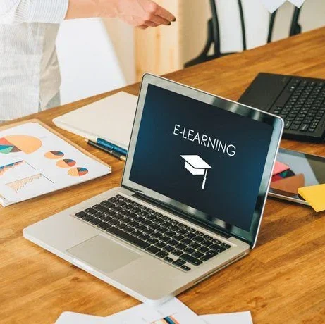 A laptop with "e-learning" written on screen